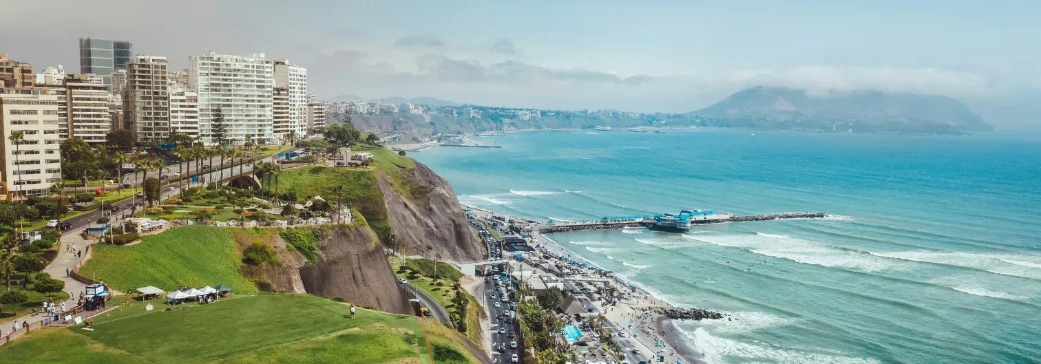 Seaside view of Lima with paragliders