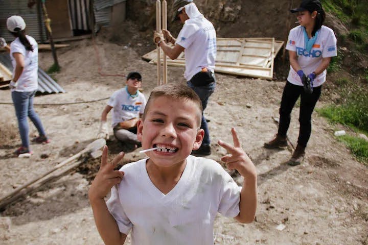 child smiling in house build project