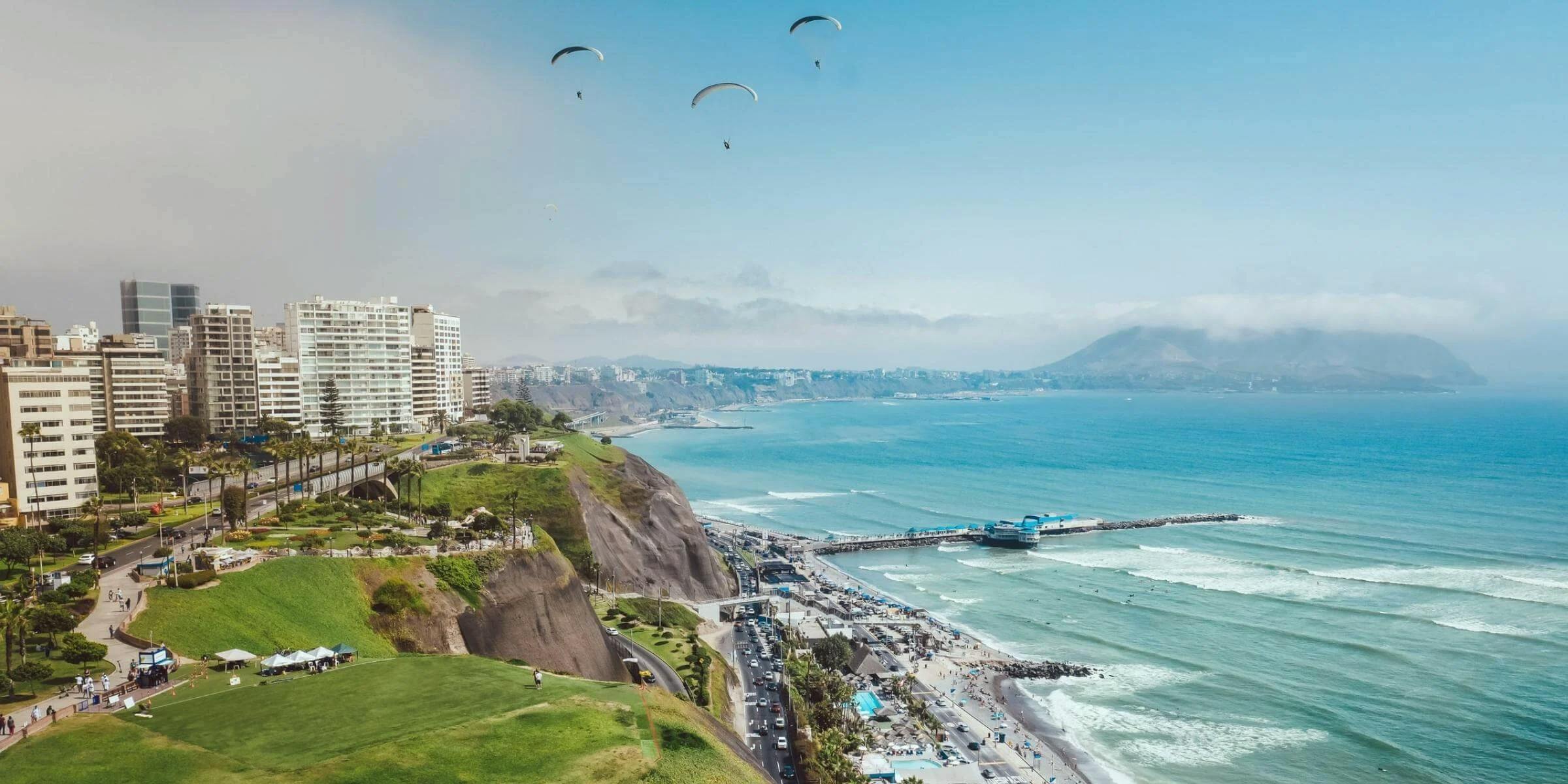 Seaside view of Lima with paragliders