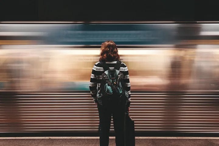 Commuter with a blurred train